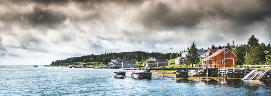 Colourful houses and small docks dot the Nova Scotia coastline
