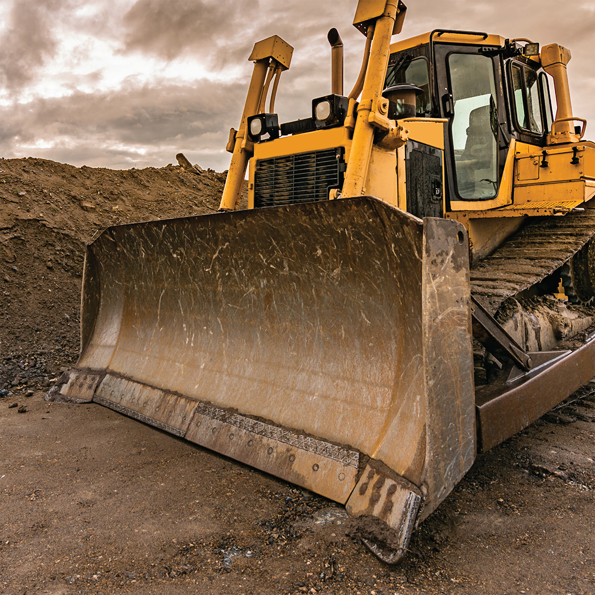 Bulldozer moving dirt for road construction