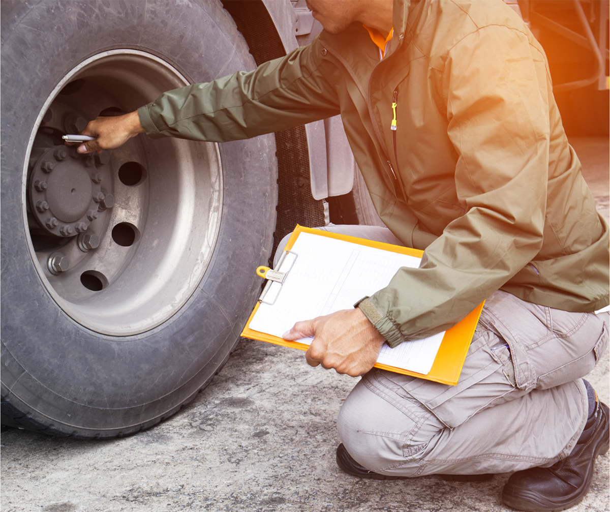 Inspections person checking safety of truck wheels