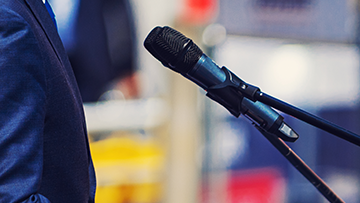 Gros plan d’une personne debout devant un microphone