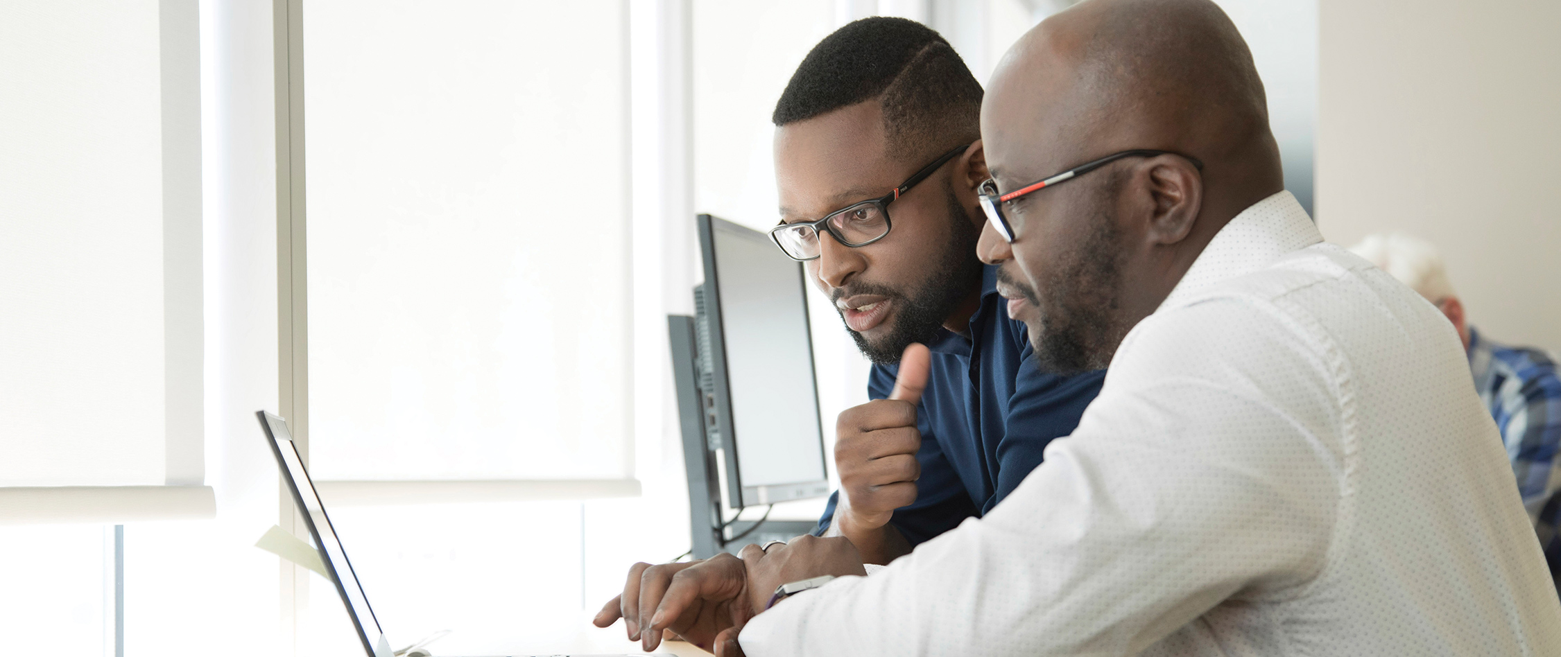 Two Analysts Looking at Laptop