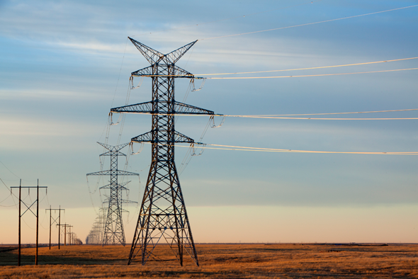 230 kilovolt and 500 kilovolt transmission lines in a grassy field