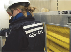 Inspectors inside an Oil Spill Containment and Response trailer