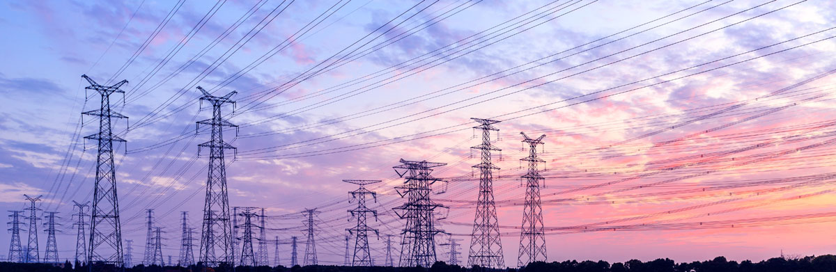 Row of power lines at sunset.