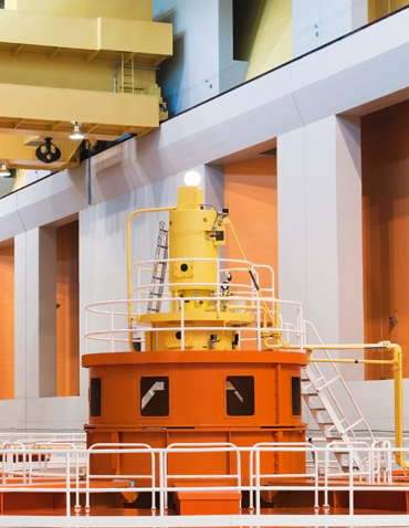 Tops of hydropower generators working at a dam; the turbines in these generators turn as the water blasts through, creating electricity.