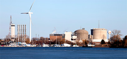 The Pickering Nuclear Generating Station located on the shore of Lake Ontario on a sunny day.