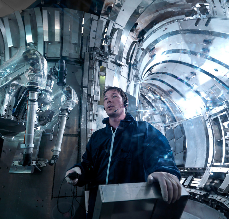 An engineer conducts a maintenance check inside a generator.