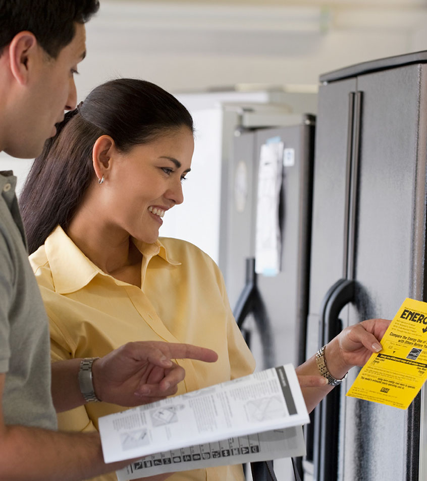 A couple shopping for an energy efficient refrigerator.