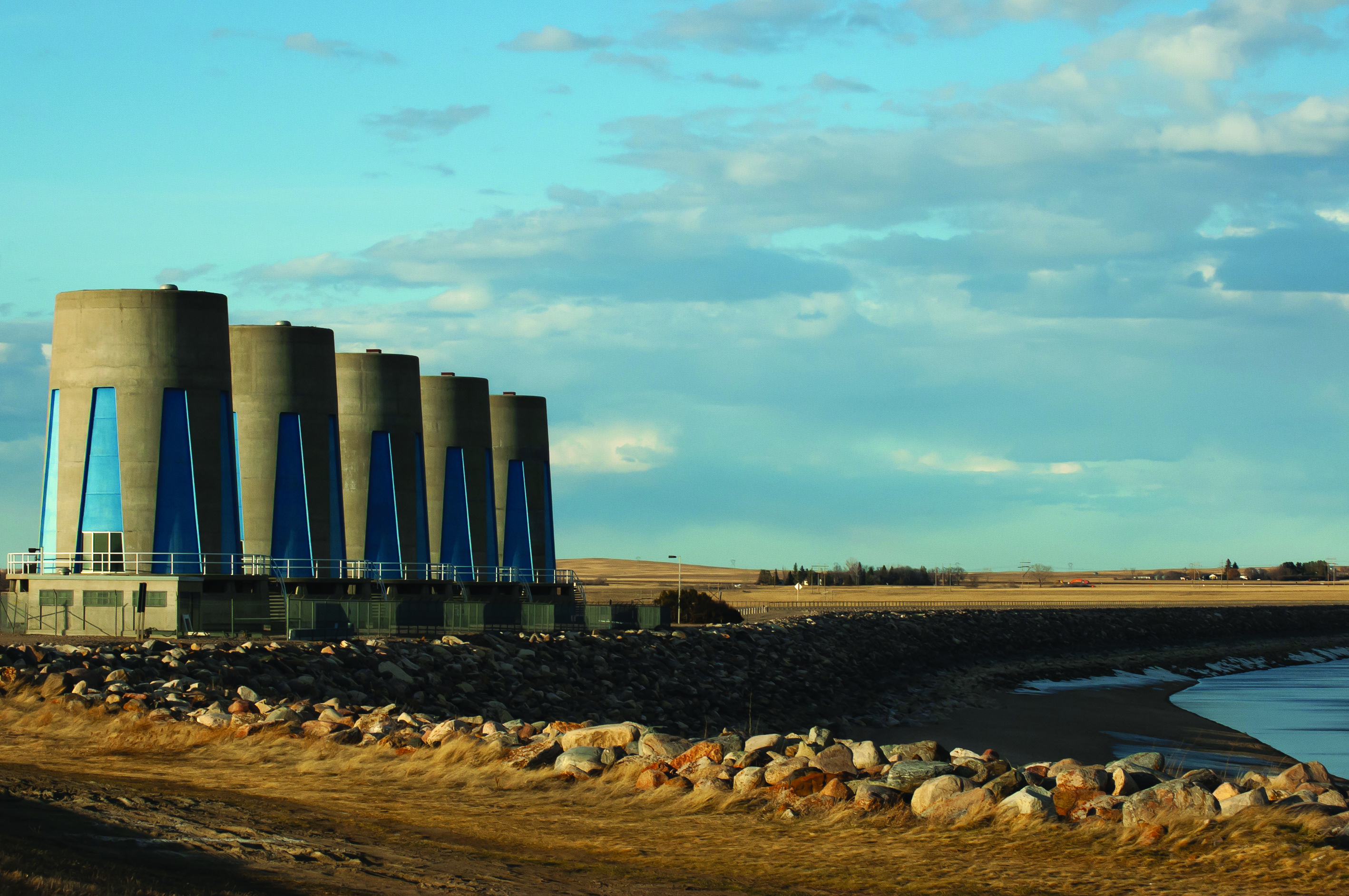 Hydroelectric towers at the Gardiner dam in Saskatchewan on an autumn day with cloudy skies.