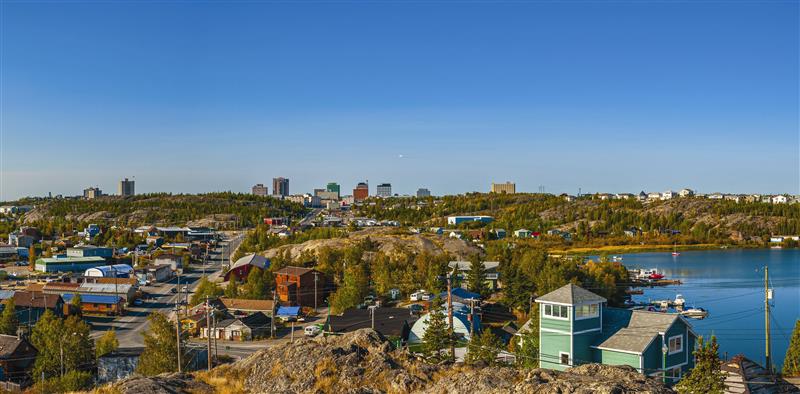 A colorful panorama of Yellowknife on a bright early autumn day with blue skies.