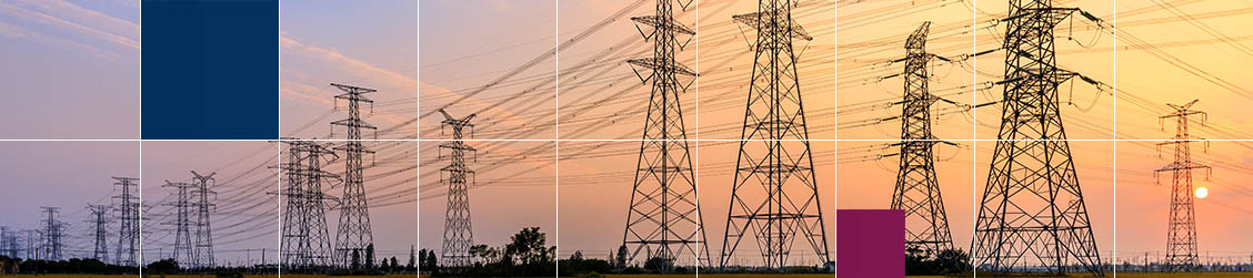 Powerlines silhouetted by a sunset.