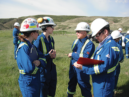 On a grassy hill a group of CER field inspectors gather for a group exercise.