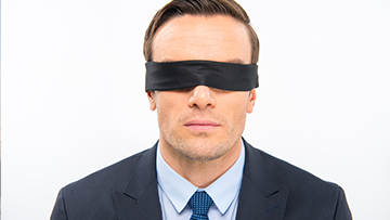 A man wearing a blindfold.